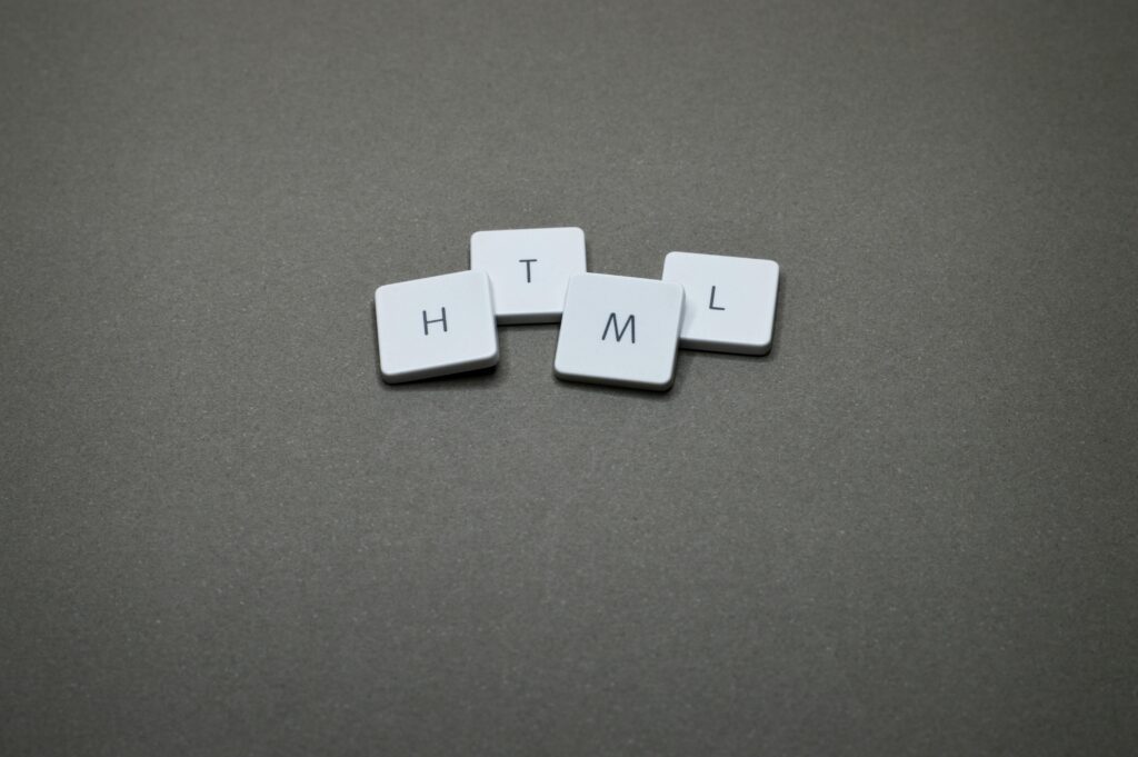 Minimalist image of HTML keycaps against a gray background, perfect for digital and web design themes.